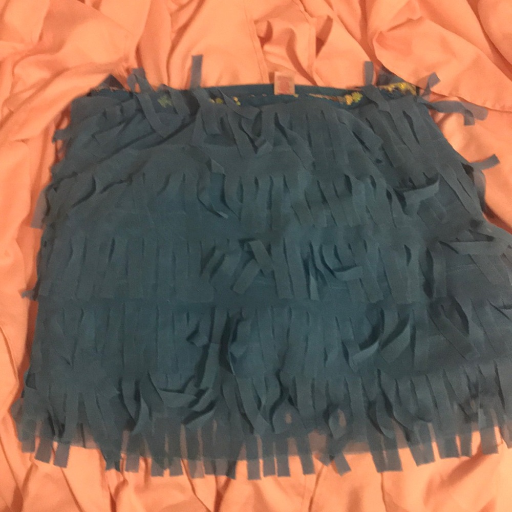 A bright blue skirt with tassels